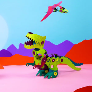 CLIXO magnetic building pieces assembled into colorful dinosaur with green body, yellow head against vibrant backdrop